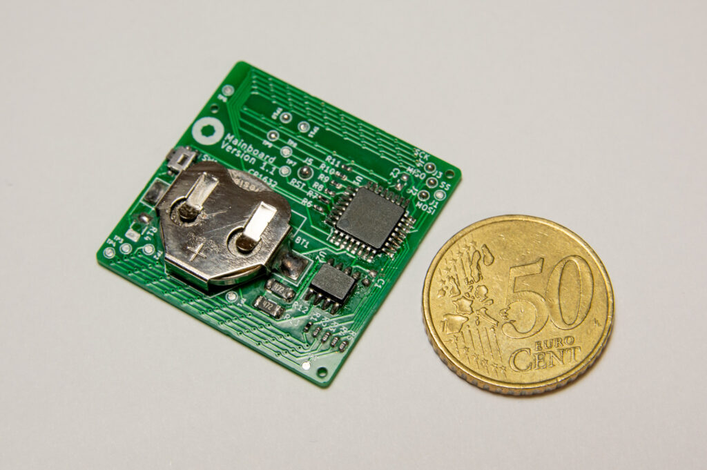 ClockSquared Mini PCB bottom side with a 50 Eurocent coin for scale